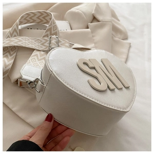 Detail of white heart-shaped PU leather bag with SM 3D letter and geometric strap