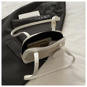 Detailed interior view of a minimalist shell bag showing large storage capacity