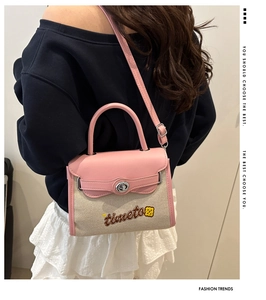 Detail of pink leather and beige canvas Kelly bag with embroidered timeto logo