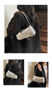 Detail view of silver balletcore shoulder bag with lace-up straps and metallic finish