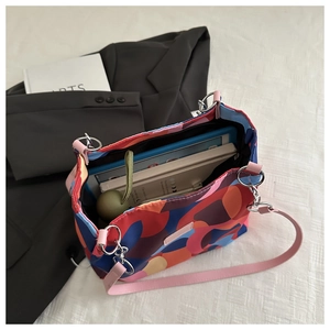 Top view of large colorful tote bag interior showing spacious storage for tablet and books