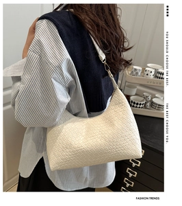 Elegant white woven PU leather armpit bag shown on a model for a chic fashion look