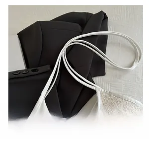 Detail shot of white crossbody tote bag showing premium 3D geometric woven texture