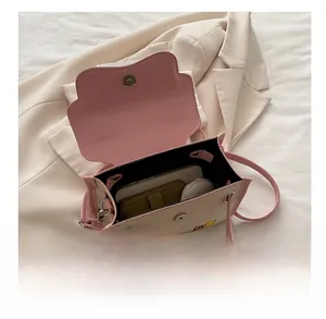 Top view of color-block flap bag showing capacity for phone, wallet and cosmetics