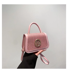 Detail of pink tweed handbag with gold M logo buckle and adjustable leather shoulder strap