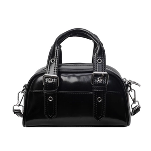 Glossy black bowling bag with silver hardware and retro decorative straps on white background