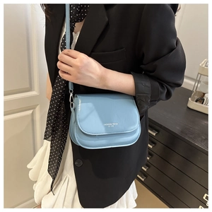 Light blue PU leather shoulder bag with white fashion trend logo worn on shoulder