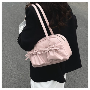 Close-up of pink tote bag featuring ribbon bows, pleated pockets and soft PU leather