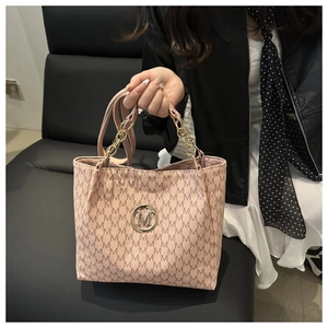 Detail of pink tote bag showing M-letter pattern and leather-metal chain strap