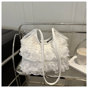 Detail of multi-layer white lace ruffles on a vintage French style summer tote bag