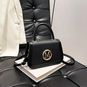 Fashionable black faux leather crossbody bag with M logo buckle and woven texture detail