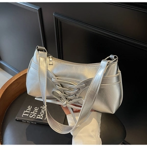 Silver metallic leather underarm bag with unique cross-lace design and zipper closure