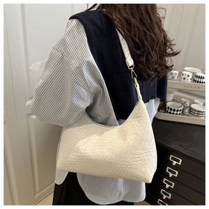 White woven texture PU leather underarm bag shown on female shoulder