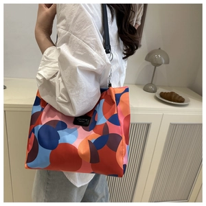Detail of vibrant colorful polka dot tote bag featuring a JINGPIN fashion side label