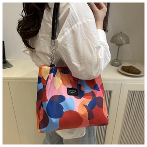 Detail of colorful printed tote bag with metal chain strap and Jingpin fashion patch