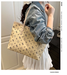 Close-up of beige tote bag with cute bear prints and sleek shoulder strap detail