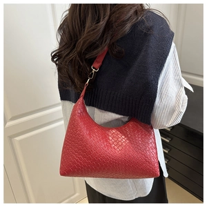 A stylish red woven PU leather underarm bag shown on a model for a trendy commuter look
