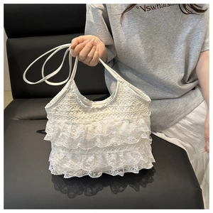 Detailed close-up of white layered lace tote bag with synthetic leather straps for women