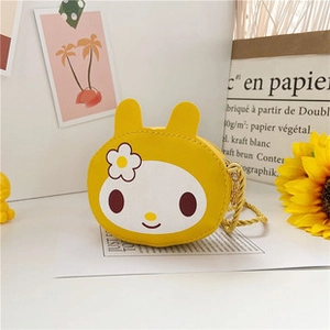 Macro detail of cartoon Melody themed mini shoulder bag in yellow with floral patterns