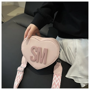 Detail of heart-shaped PU crossbody bag with SM 3D letters and woven shoulder strap