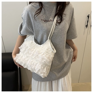 Detailed view of layered white lace ruffles and soft fabric texture on this tote bag