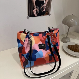 Fashionable tote bag with colorful abstract geometric prints and leather chain straps