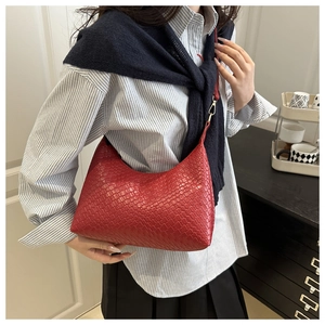 Trendy red woven PU underarm bag styled on a model with a blue striped shirt