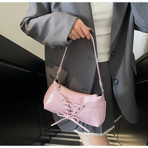 Detailed view of pink glossy PU leather shoulder bag with chic ribbon bow decoration