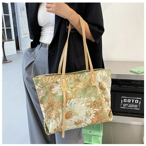 Artistic jacquard floral tote bag shown on shoulder with vintage tapestry texture