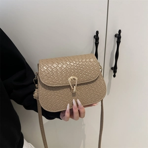 Beige woven texture crossbody bag with vintage gold U-shaped metal buckle detail