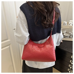Back view of a red woven PU underarm bag on a model showing lifestyle usage