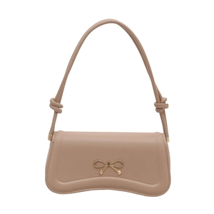 Beige faux leather shoulder bag with a gold bow buckle and knotted strap details
