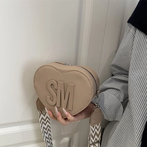 Chic heart-shaped crossbody bag in beige PU leather with SM logo and wide wavy strap