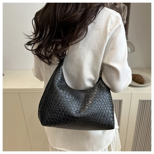 Back view of a model wearing a black woven PU leather hobo shoulder bag for daily use