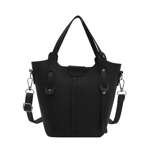Large black pebbled leather bucket bag with top handles and adjustable shoulder strap