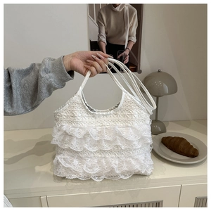 Detail of white lace ruffle layers on elegant lady's tote bag in a cozy home setting
