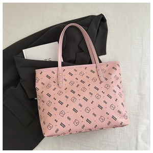 Detailed shot of pink tote bag with bear print on textured faux leather surface