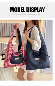 Detail of red checkered canvas tote and navy denim shoulder bag on a bookshelf