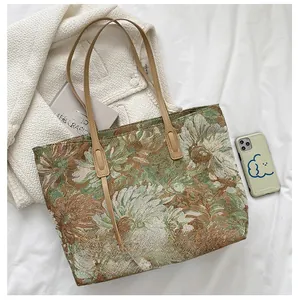 Detailed close-up of vintage floral jacquard tote bag with premium brown leather handles