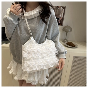 Detailed close-up showing the layered white lace texture and delicate ruffles of the tote bag