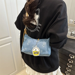 Blue denim shoulder bag with white bear print and yellow leather strap with cupcake charm