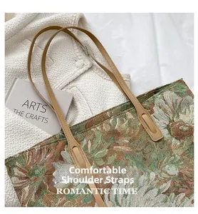 Detail of vintage floral jacquard tote bag with high-quality brown leather shoulder straps