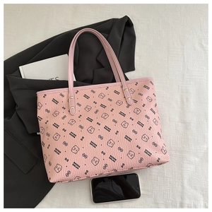 Detail of pink PU leather tote bag with black bear print and gold-tone rivet hardware