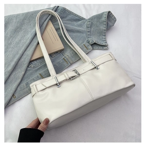 Detail of white faux leather shoulder bag with silver buckle and elegant strap detail