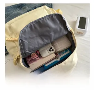 Detailed internal view showing large capacity storage of the minimalist yellow backpack