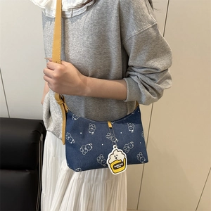 Blue denim underarm bag with white bear print and yellow shoulder strap for women