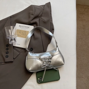 Silver PU metallic underarm bag with lace-up detail styled with artistic books