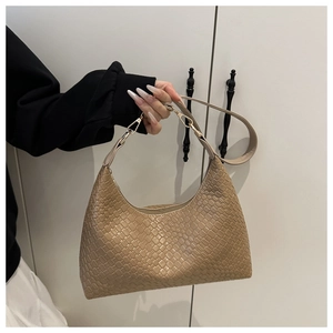 Detailed view of a stylish khaki woven pattern PU underarm bag being held by a hand