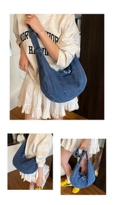 Detail of adjustable wide shoulder strap and denim material on a stylish blue hobo tote bag
