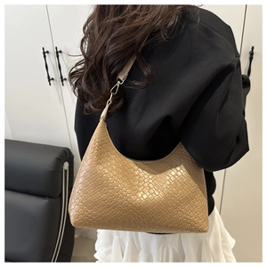 Modern minimalist beige woven PU leather hobo bag shown being worn as an underarm bag.
